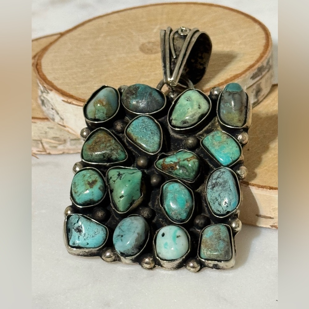 Turquoise cluster pendant set in Tibetan Silver. 16 nuggets, 2”x2”